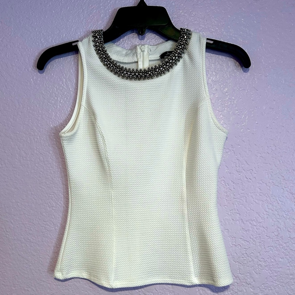 Sleeveless white top with jeweled neck